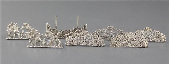 A pair of early repousse silver menu holders, Rosenthal, Jacob & Co, circa 1900, a set of four unmarked menu holders & 1 other